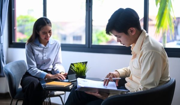 two-young-employees-talking-each-other-break-office_35674-5697